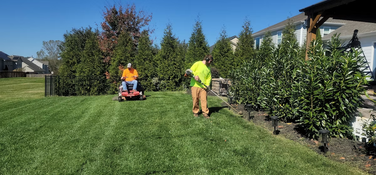 A Second Chance Cuts crew member detailing a manicured yard
